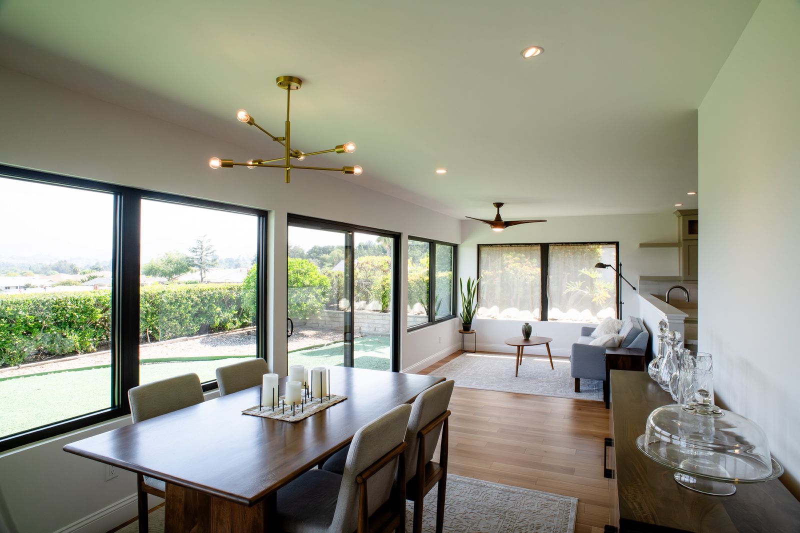 Rancho Bernardo ground-floor addition: an open dining and living room with a wall of windows and white oak floors