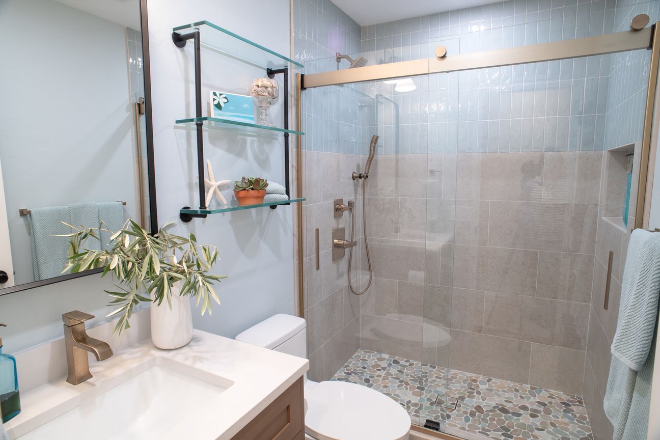Mira Mesa hall bathroom remodel with a glass walk-in shower, a pebble shower floor and a white oak vanity