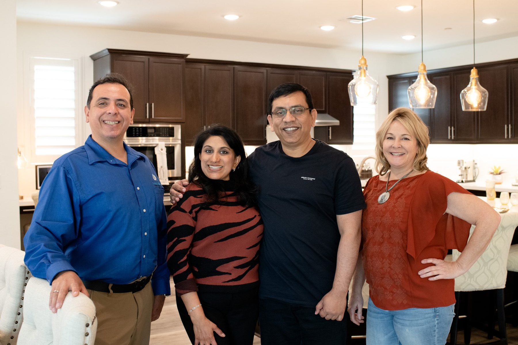 Kaminskiy designers with homeowners in their finished kitchen