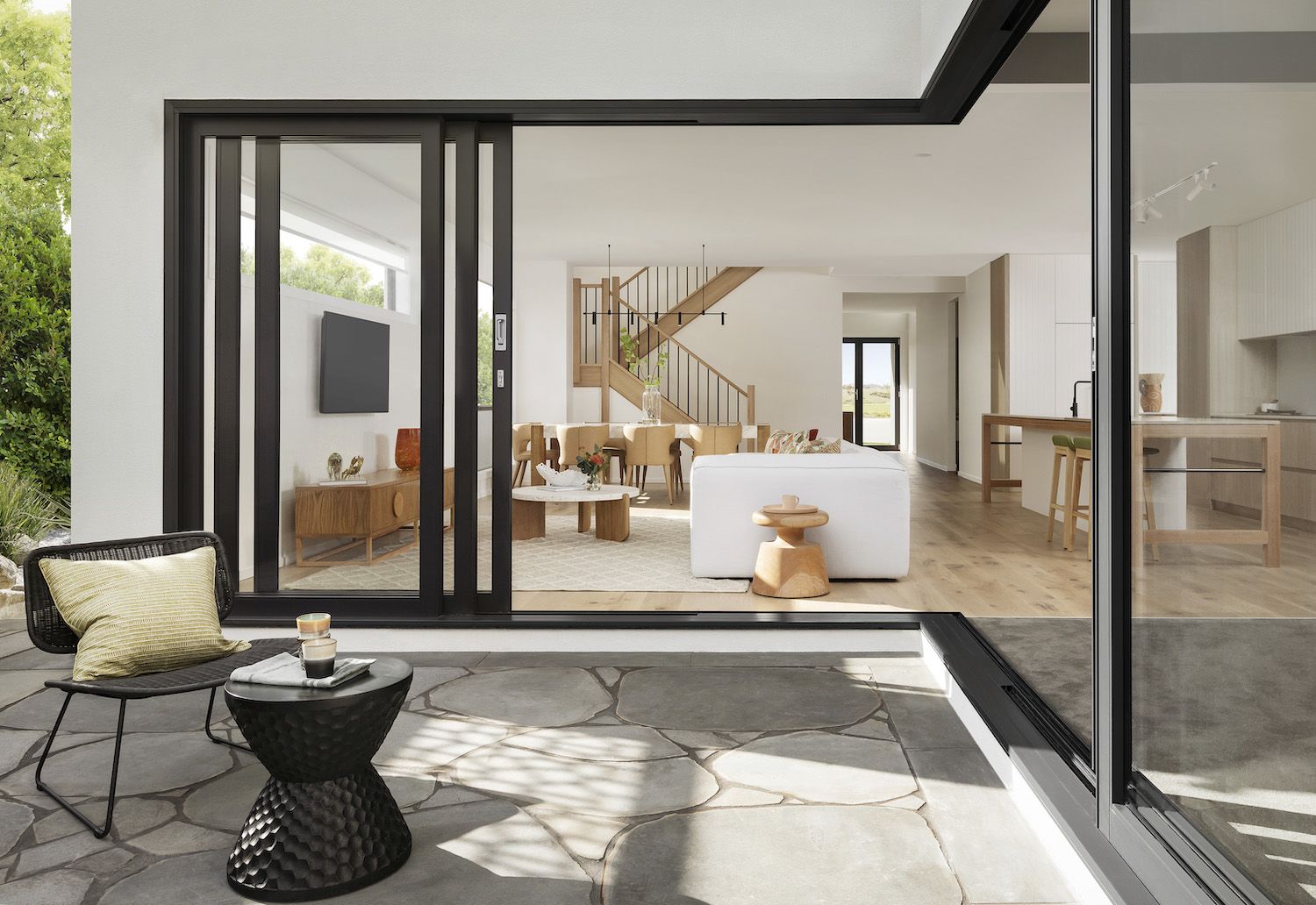 A Kaminskiy whole-home remodel with open living space and large glass doors to the yard