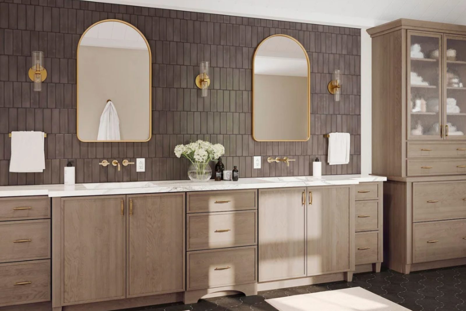An express bathroom remodel: a double vanity in light oak with arched brass mirrors and a tiled accent wall