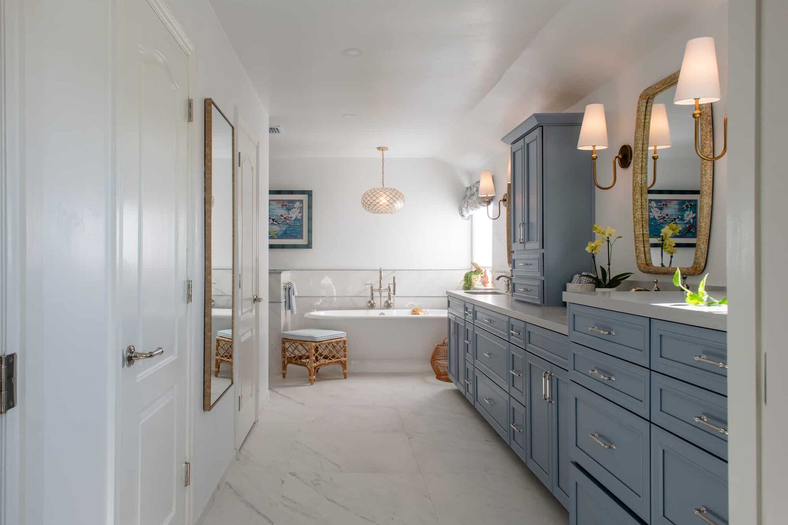 Wide view of El Cajon primary bathroom remodel with blue double vanity and freestanding soaking tub