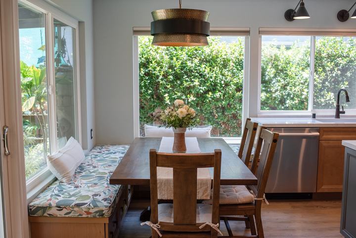 Built-in banquette with a patterned cushion running along two windows