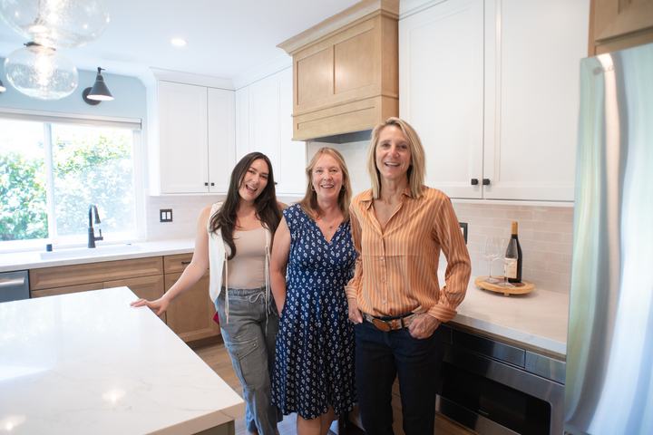 Designers Andrea and Haley with the client after the remodel