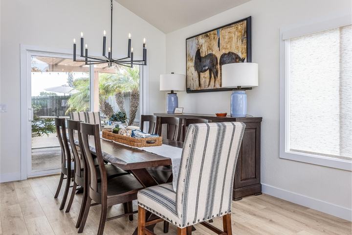 Dining room with black chandelier and rustic table