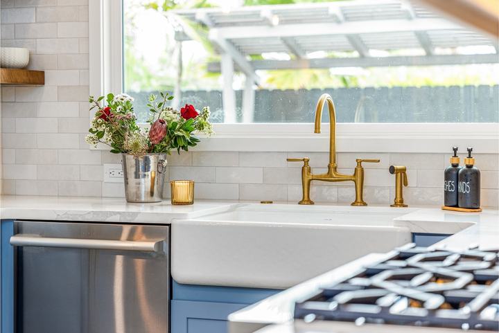 Apron sink, brass bridge faucet, quartz counter