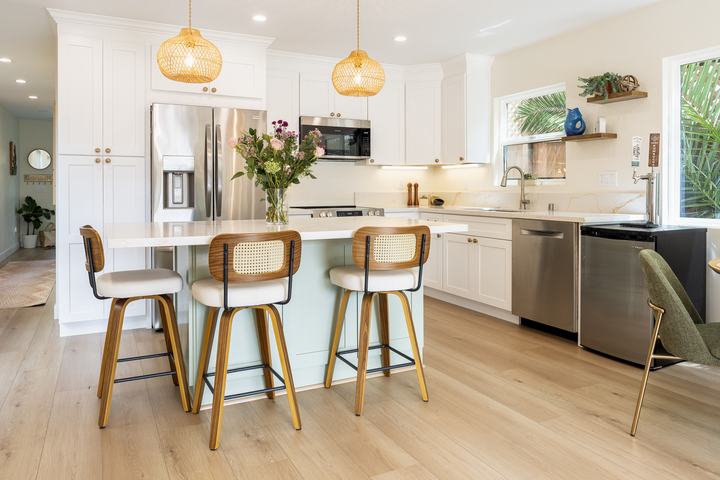Island overhang with cane stools and warm brass accents