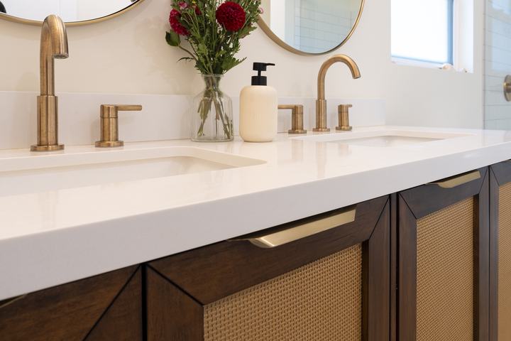 Quartz vanity top with champagne-bronze widespread faucets