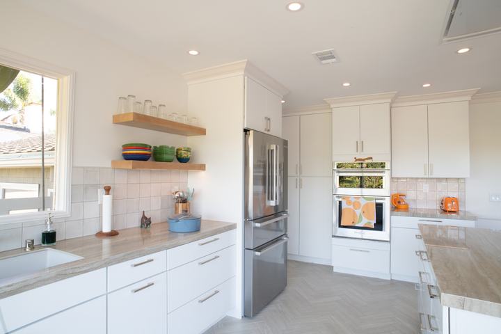 Maple floating shelves, refrigerator, and oven wall seen from the sink side
