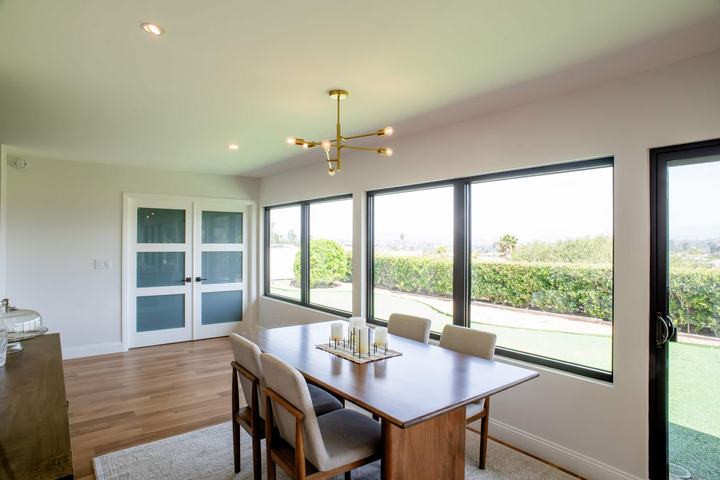 Dining area with large windows and white oak floors in a Rancho Bernardo remodel