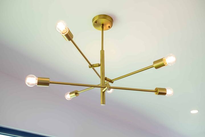 Gold chandelier lighting in the open dining area