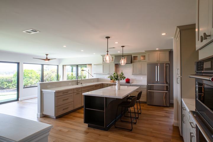 Open-concept kitchen with island seating and white oak hardwood floors