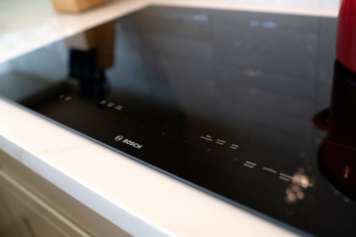 Bosch induction cooktop set into Calacatta-style kitchen countertop