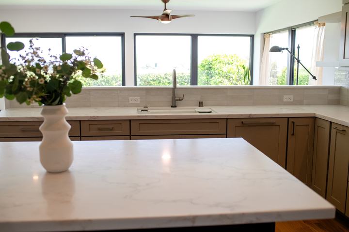 Kitchen island and sink wall with large windows in open-concept remodel