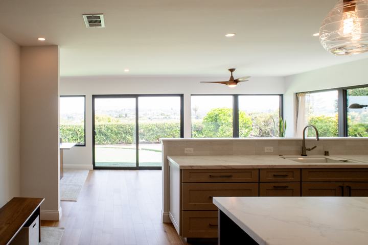 Open kitchen and living area with white oak flooring and widened opening