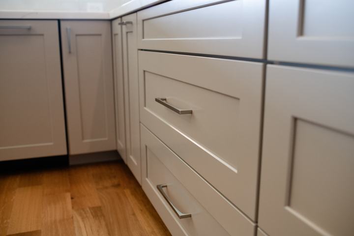 Oatmeal shaker kitchen cabinets with brushed metal hardware