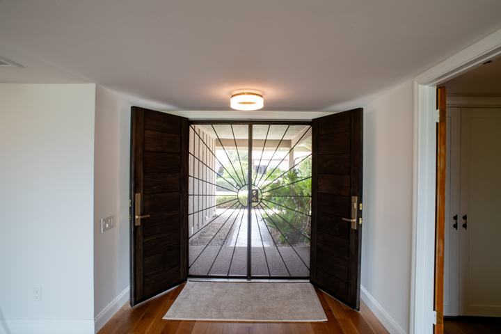 Interior view of dark wood front entry doors in Rancho Bernardo remodel