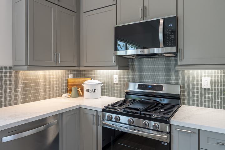 Corner view of quartz counters and stainless range