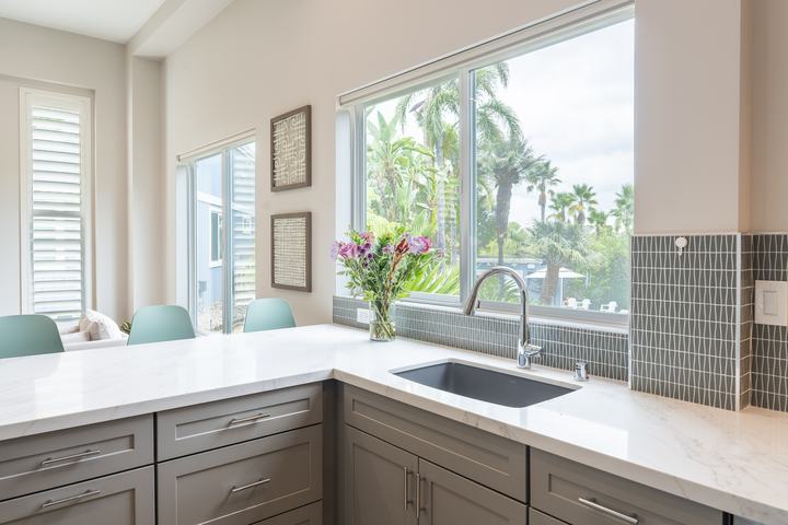 Undermount Silgranit sink below window and tile splash