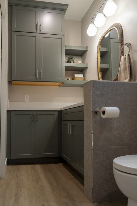 Tall linen cabinets with floating shelves in ADU bath