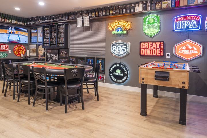 Neon brewery wall with foosball and poker table