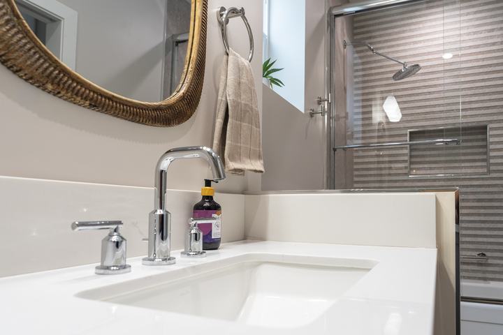 Rectangular sink with chrome widespread faucet and backsplash