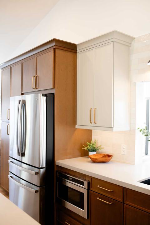 Refrigerator, microwave drawer, and surrounding cabinetry