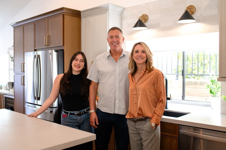 Designers and client group photo in the completed kitchen remodel